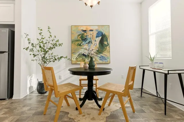 a view of a dining room with furniture and a potted plant