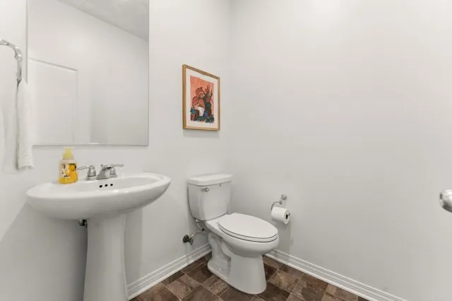 a bathroom with a sink mirror and toilet