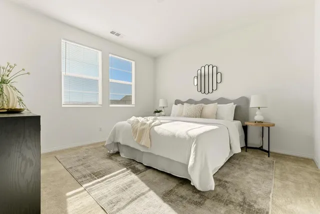 a bedroom with a bed and window