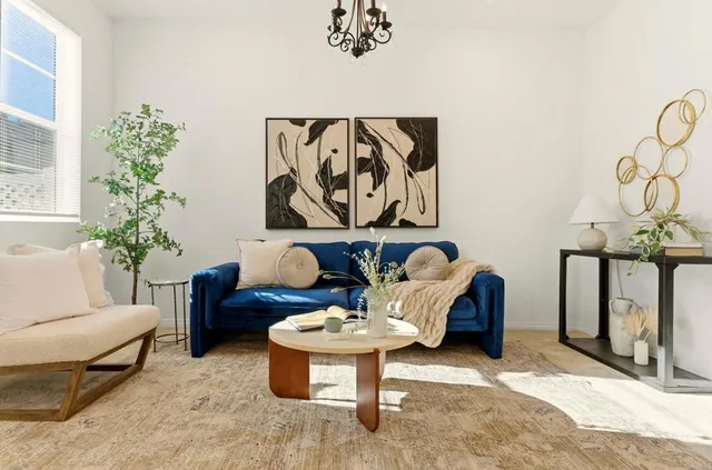 a living room with furniture and flowers