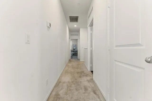 a view of a hallway with wooden shelves