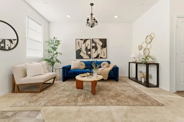 a living room with furniture and a chandelier
