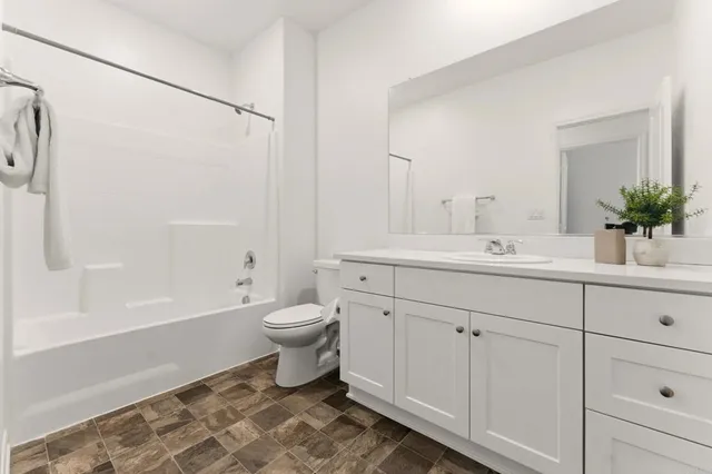 a bathroom with a sink toilet a mirror and shower