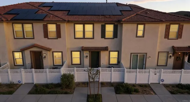 a front view of a house with table and chairs