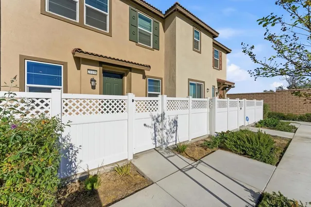 an aerial view of residential houses with outdoor space and ocean view