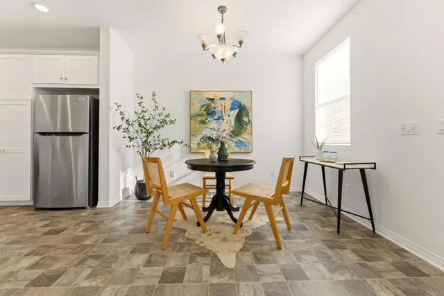 a view of a dining room with furniture and a chandelier