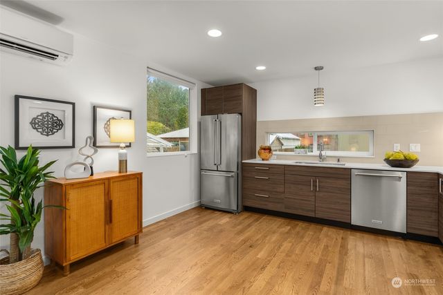 a kitchen with a refrigerator and a stove top oven