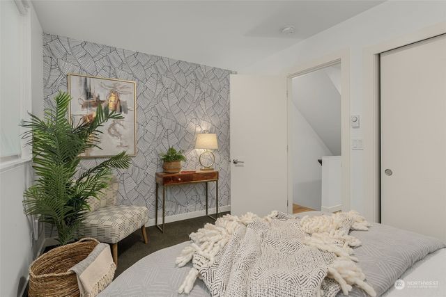 a bedroom with a bed and a potted plant