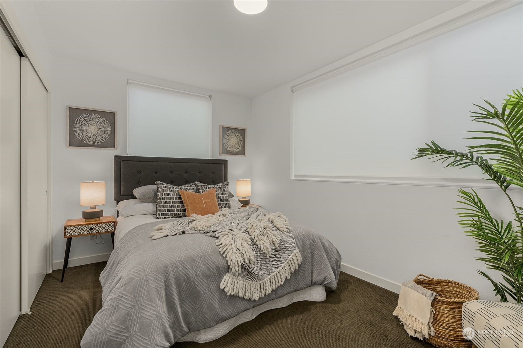 2440 55th Avenue Southwest Seattle, WA 98116 - Photo 16 of 30 a bedroom with a bed and a potted plant