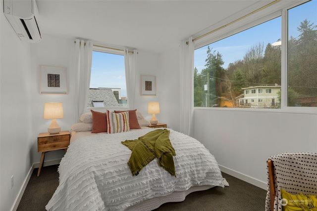 a bedroom with a large bed and a window