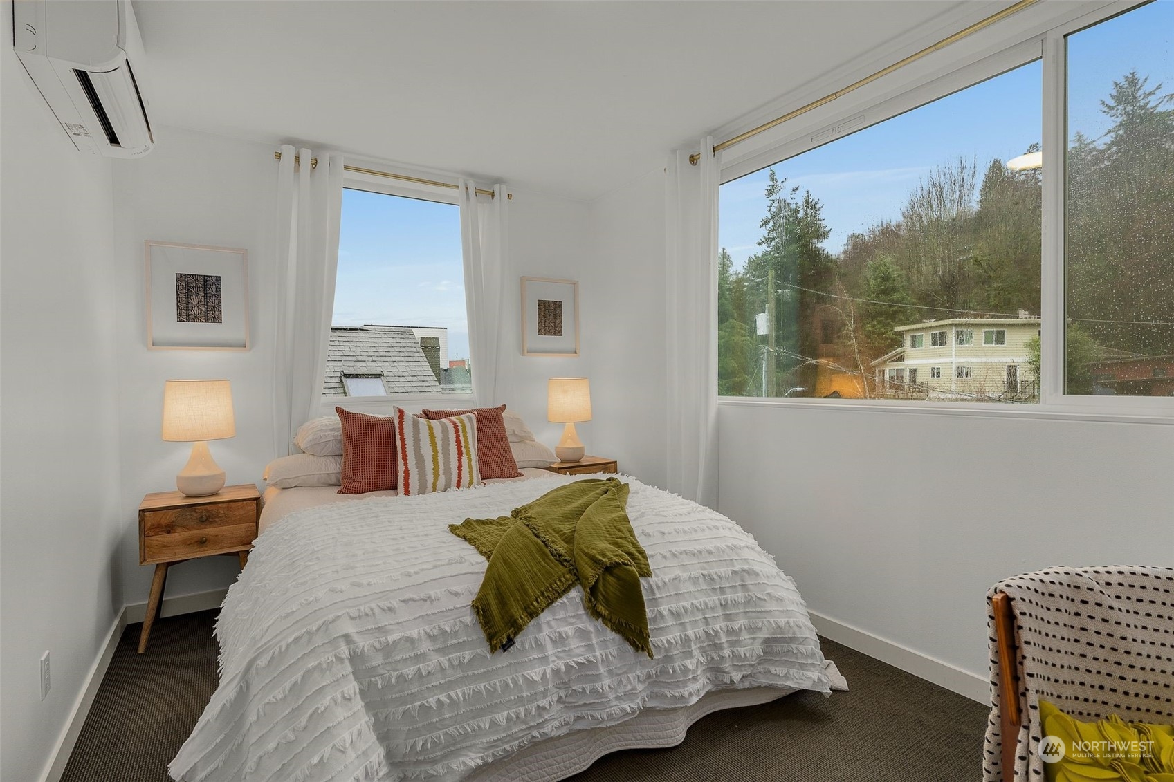 2440 55th Avenue Southwest Seattle, WA 98116 - Photo 19 of 30 a bedroom with a large bed and a window