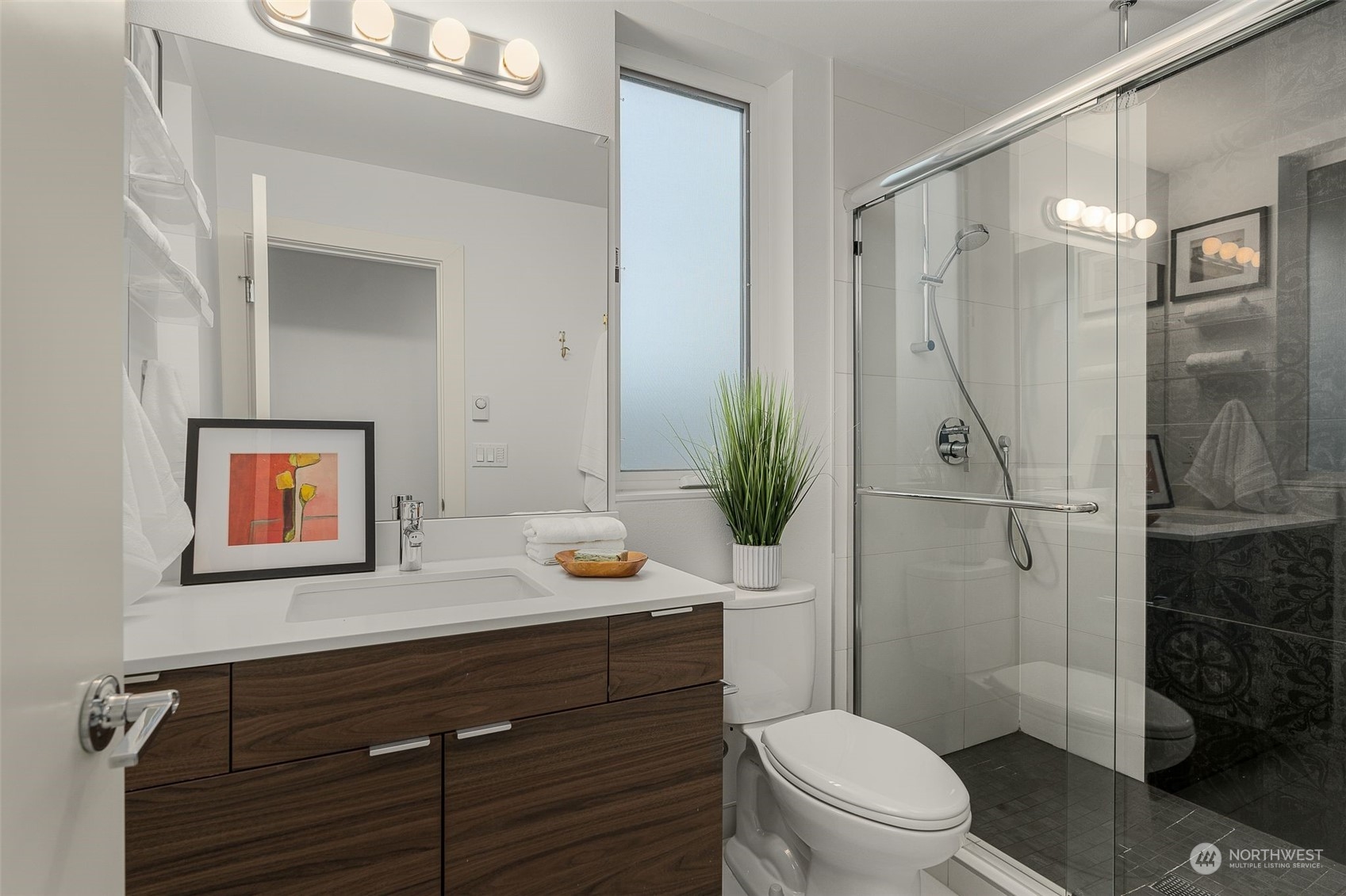 2440 55th Avenue Southwest Seattle, WA 98116 - Photo 21 of 30 a bathroom with a granite countertop sink toilet a mirror and shower