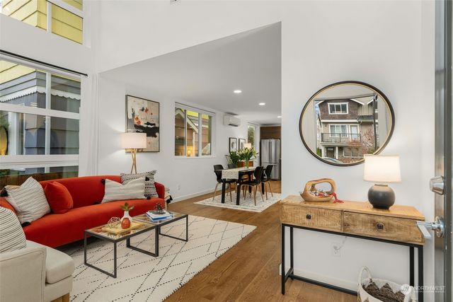 a living room with furniture a mirror and a window
