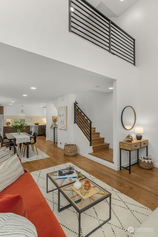 a living room with furniture a rug and a table