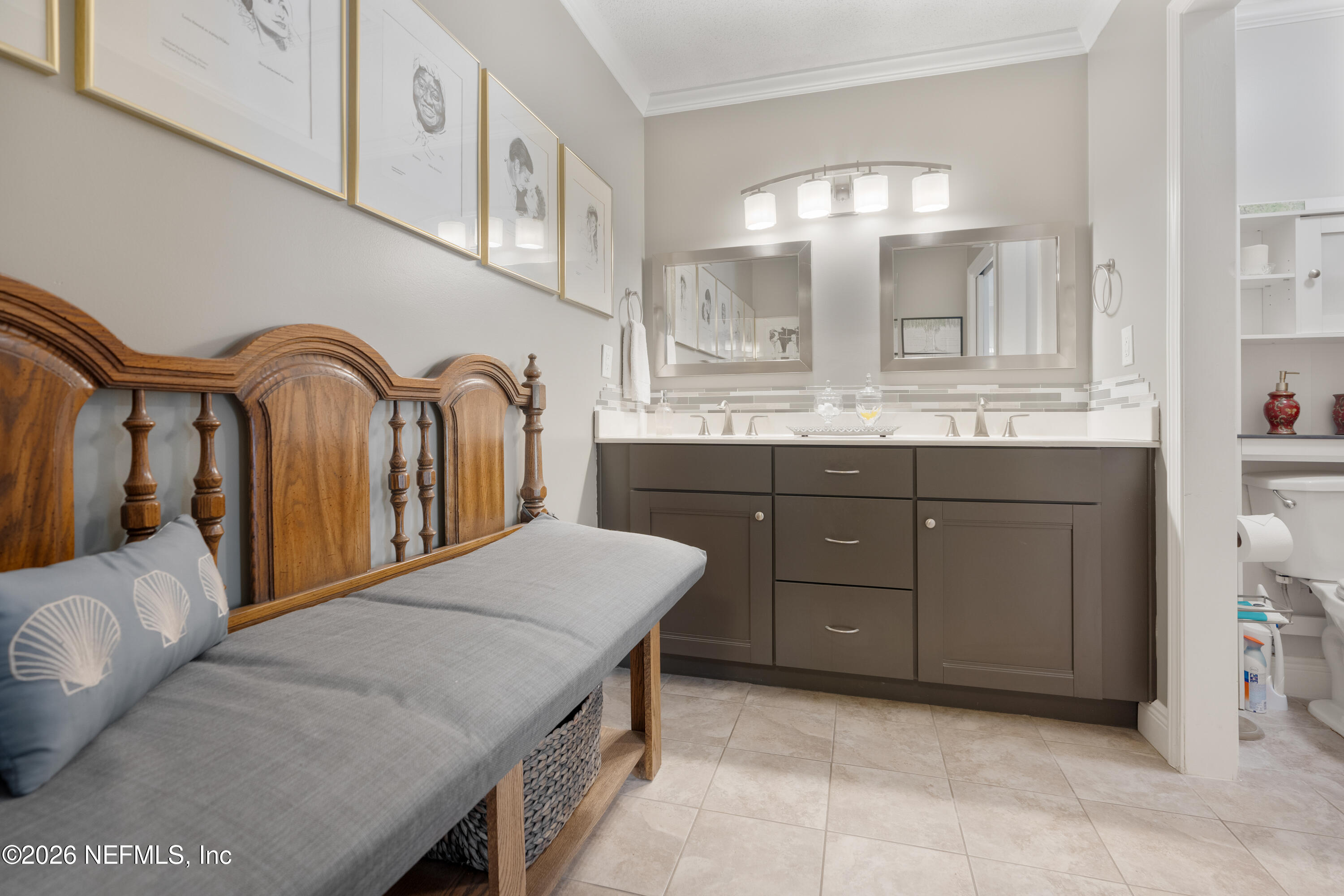 204 Gerado Street, Unit 3 St. Augustine, FL 32080 - Photo 18 of 31 a en suite bathroom with a granite countertop sink a mirror and a
