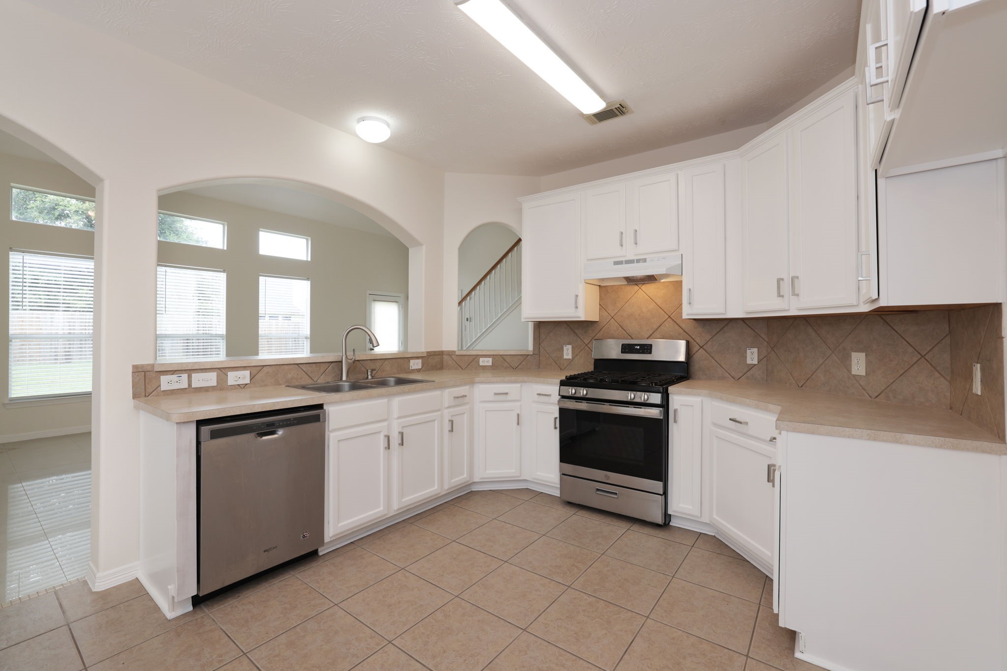 3031 Country Boy Court Spring, TX 77373 - Photo 10 of 35 a kitchen with granite countertop white cabinets and white appliances