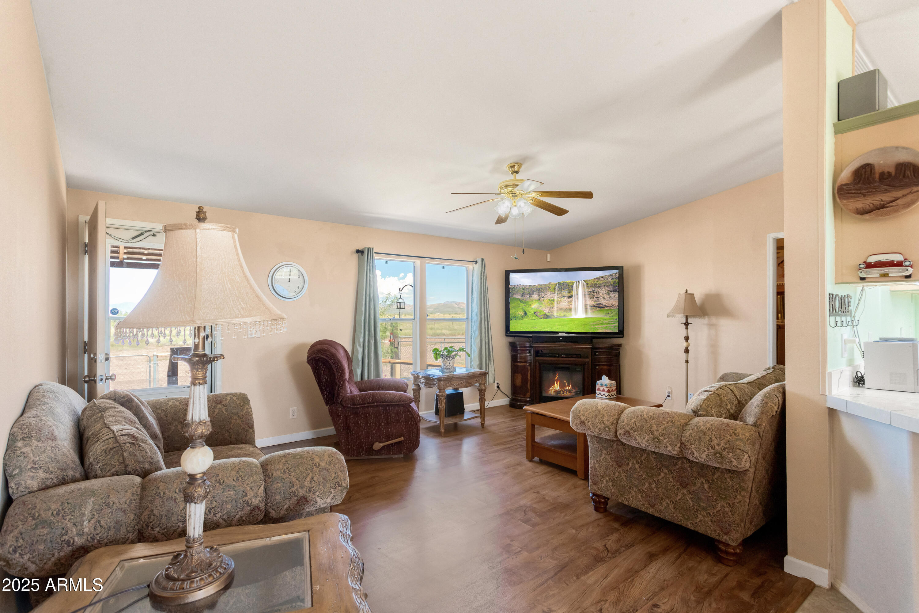 1907 East Vía Ocotillo Douglas, AZ 85607 - Photo 12 of 49 a living room with furniture and a flat screen tv with wooden floor