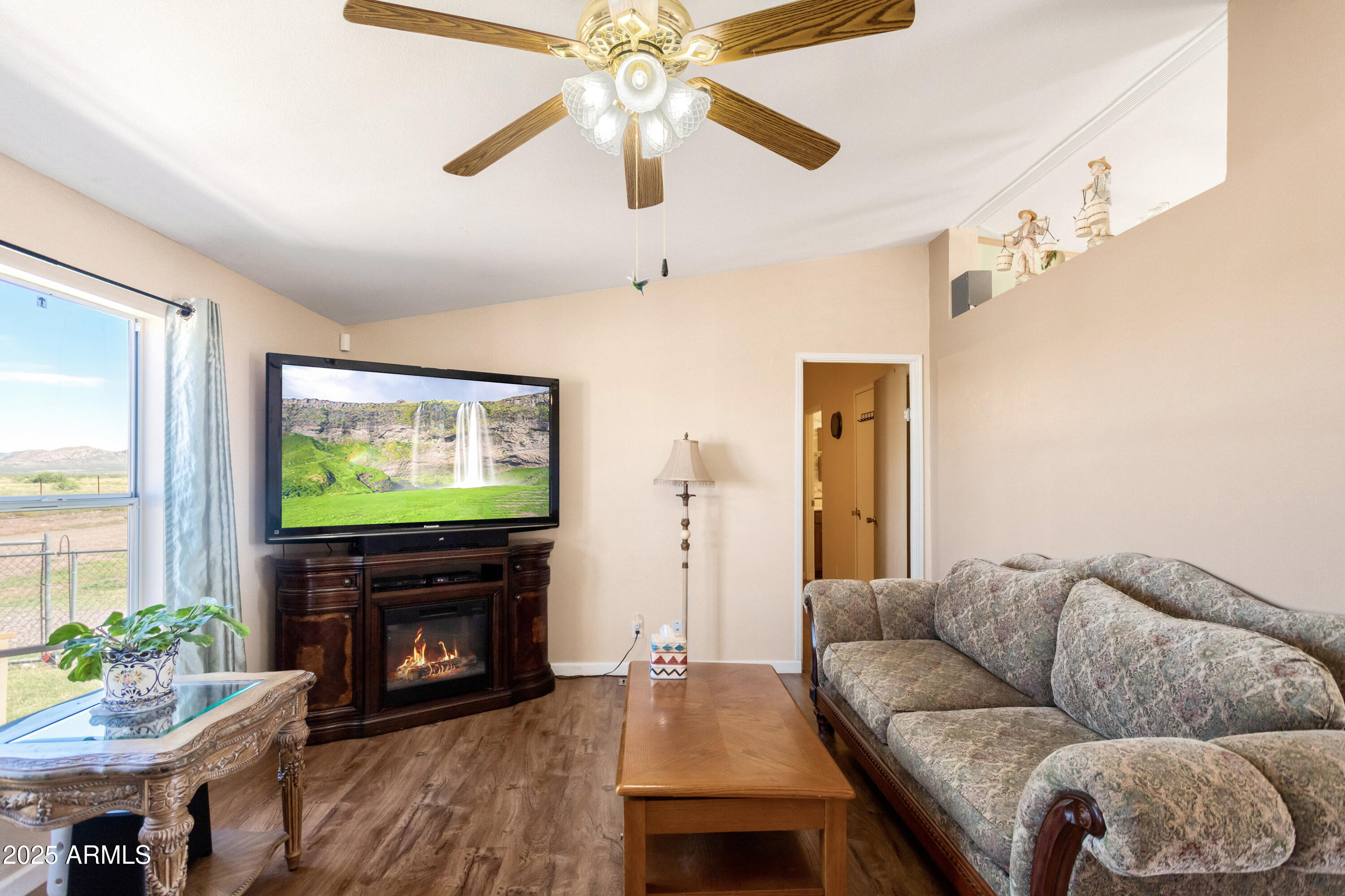 1907 East Vía Ocotillo Douglas, AZ 85607 - Photo 13 of 49 a living room with furniture a flat screen tv and a fireplace