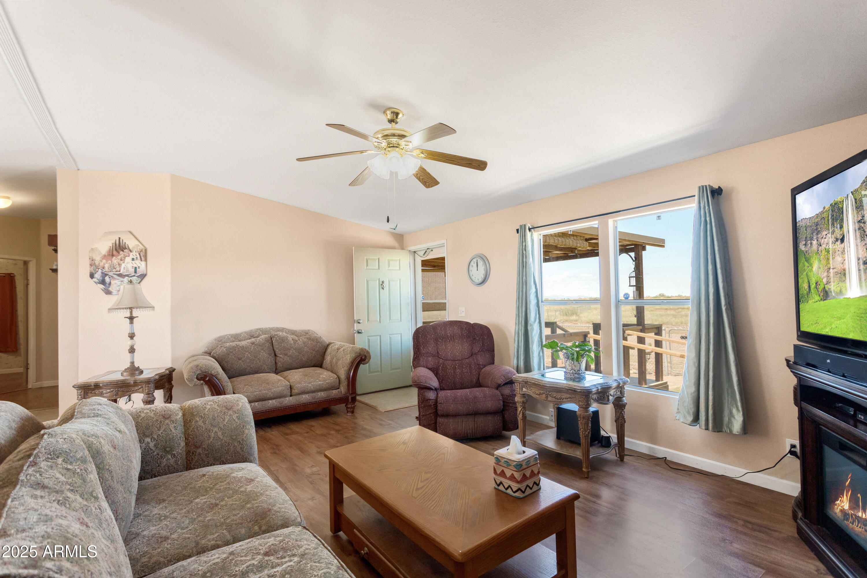 1907 East Vía Ocotillo Douglas, AZ 85607 - Photo 14 of 49 a living room with furniture and a flat screen tv with wooden floor