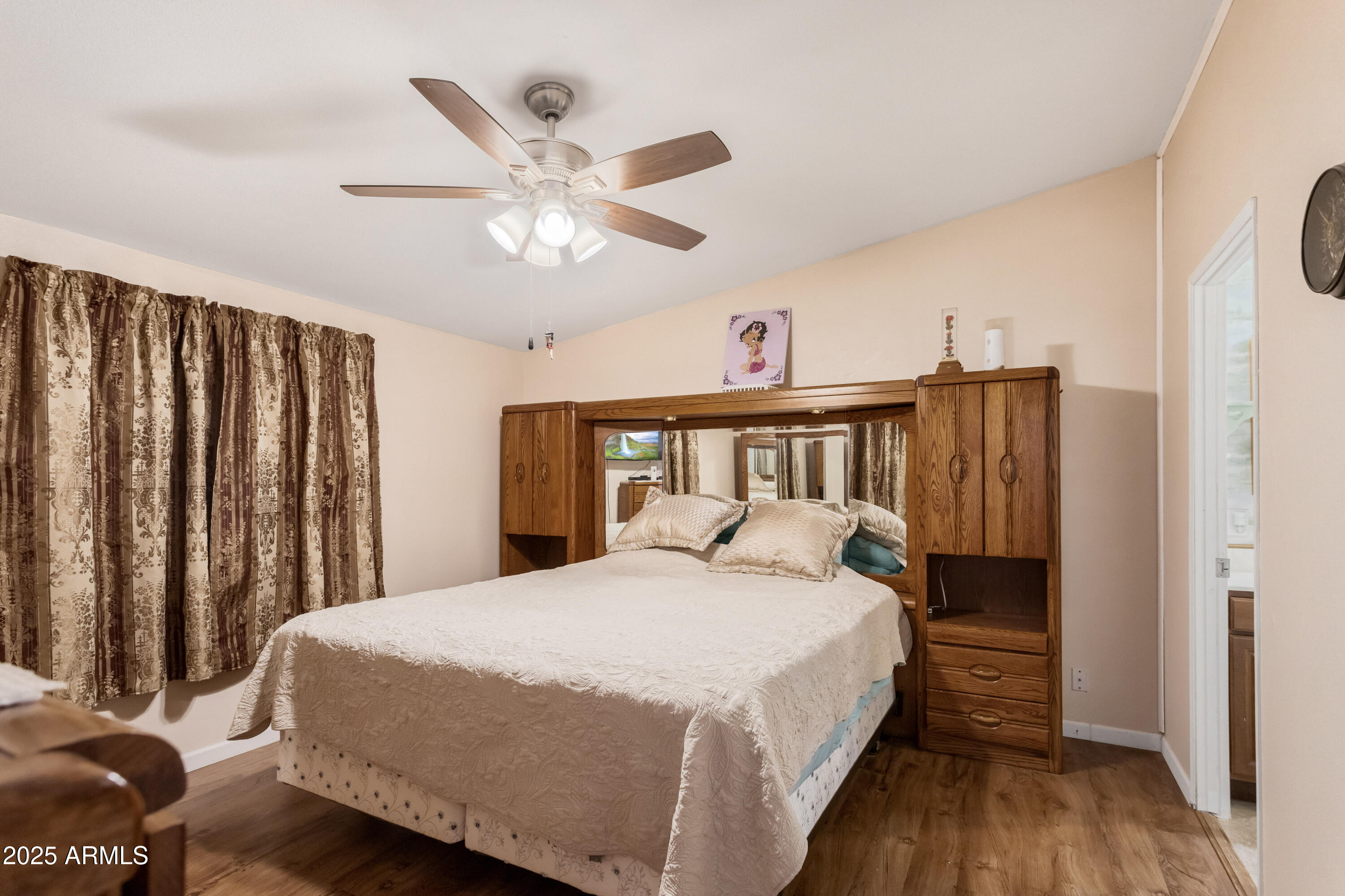 1907 East Vía Ocotillo Douglas, AZ 85607 - Photo 15 of 49 a bedroom with a large bed and a chandelier