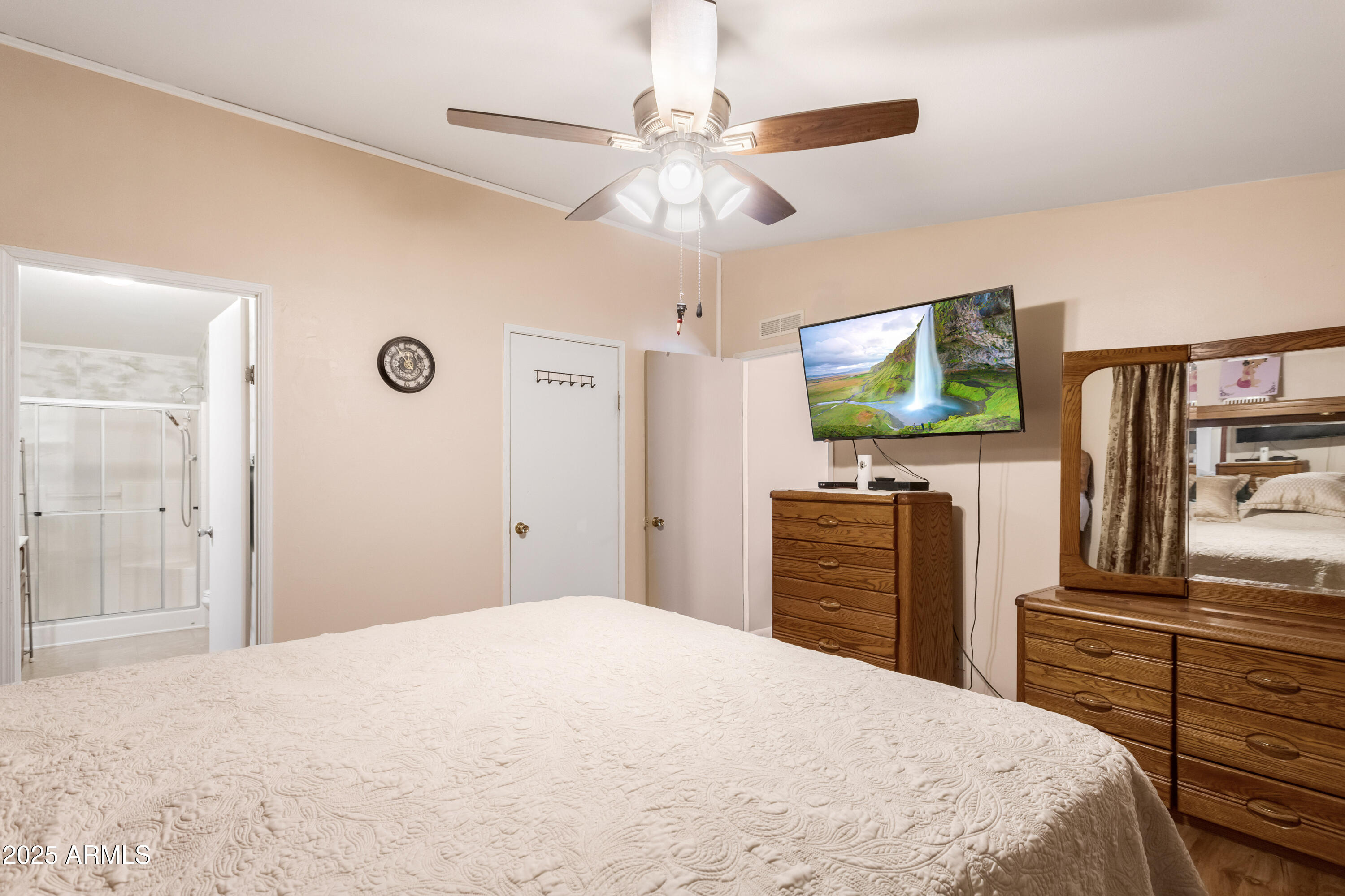 1907 East Vía Ocotillo Douglas, AZ 85607 - Photo 16 of 49 a bedroom with a bed and a flat tv screen on dresser