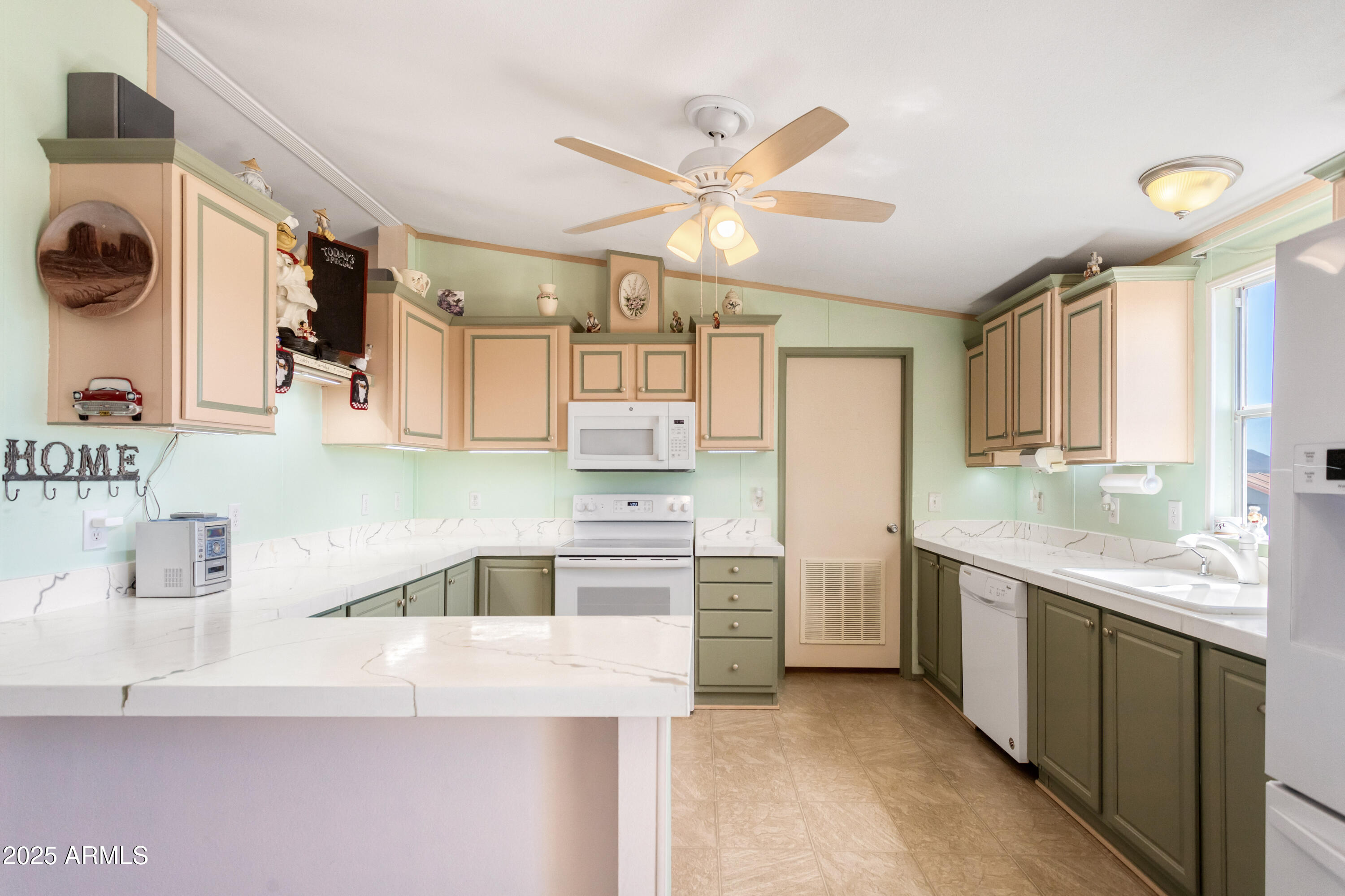 1907 East Vía Ocotillo Douglas, AZ 85607 - Photo 6 of 49 a kitchen with a sink a stove and cabinets