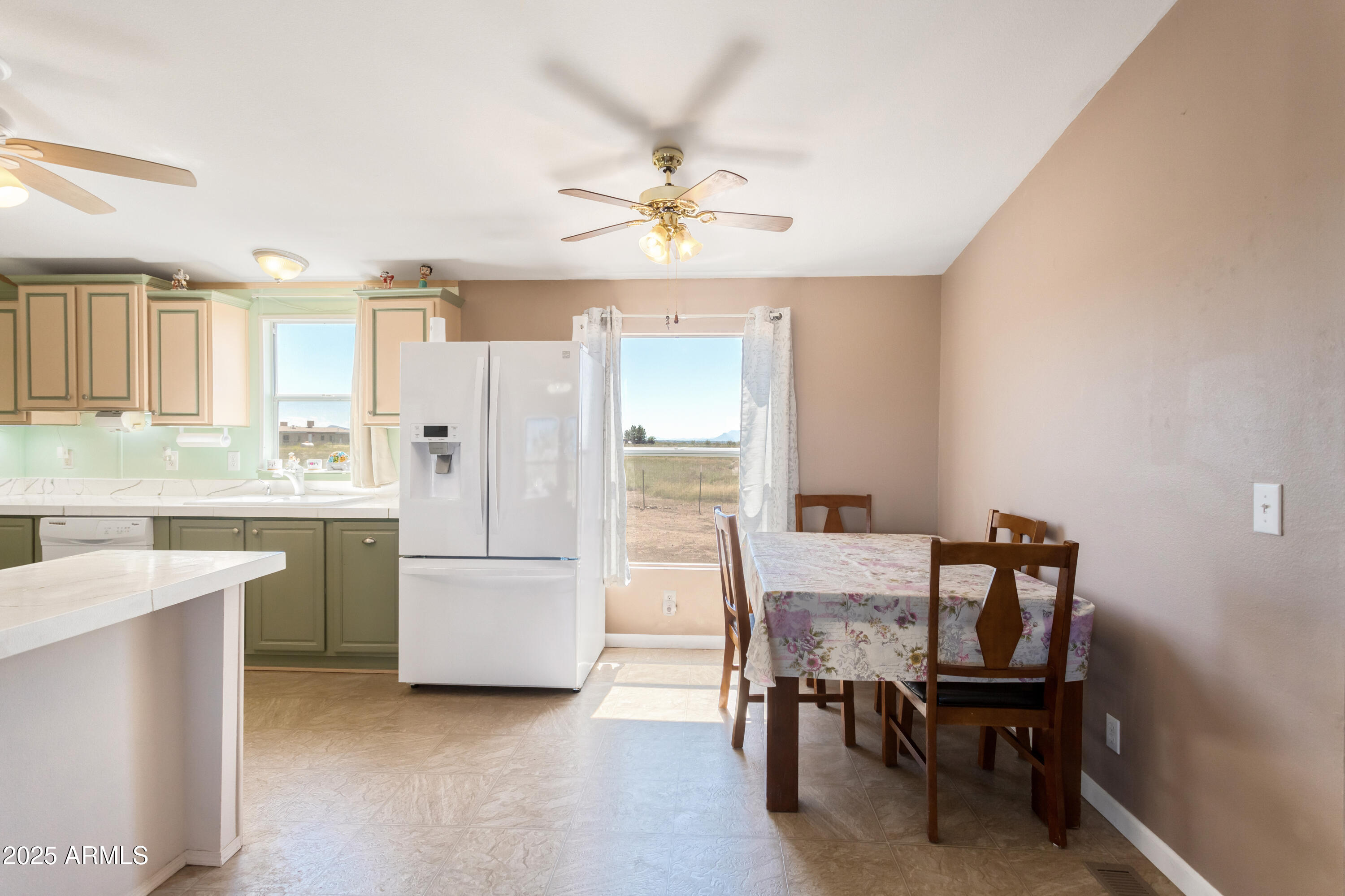 1907 East Vía Ocotillo Douglas, AZ 85607 - Photo 10 of 49 a kitchen with a table chairs refrigerator and microwave