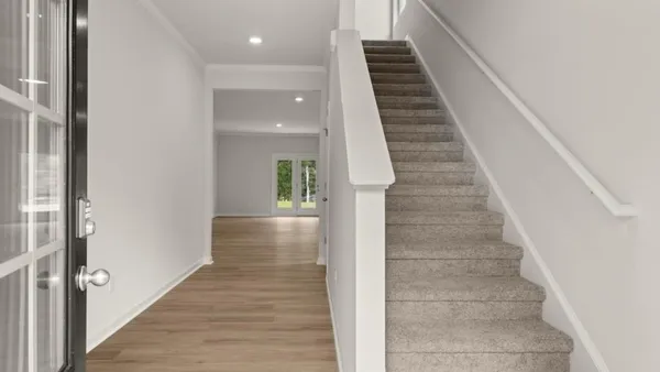 a view of entryway and hall with wooden floor