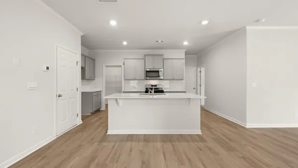 a view of kitchen with stainless steel appliances refrigerator sink and cabinets