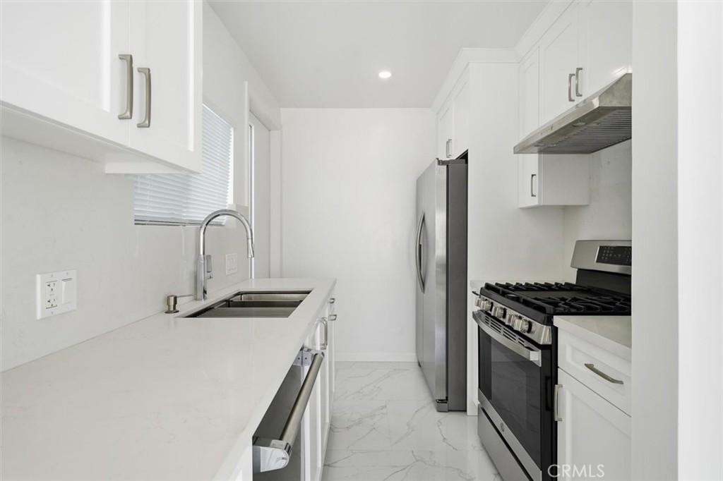 220 39th Street, Unit B Manhattan Beach, CA 90266 - Photo 8 of 21 a kitchen with granite countertop a sink stove and refrigerator
