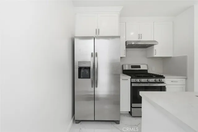 a kitchen with a stove and a refrigerator