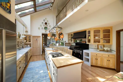 a kitchen that has a lot of cabinets in it and appliances
