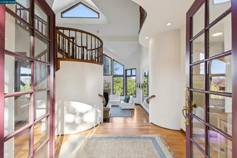 a view of an entryway with wooden floor and a potted plant