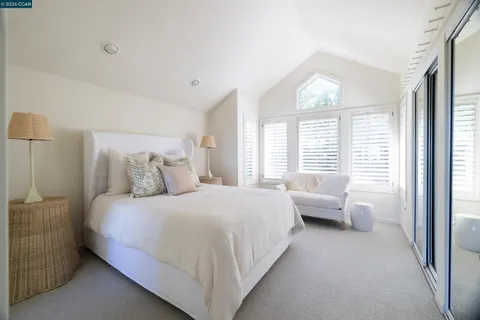 a bedroom with a large bed and a large window