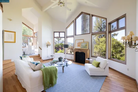 a living room with furniture fireplace and a large window
