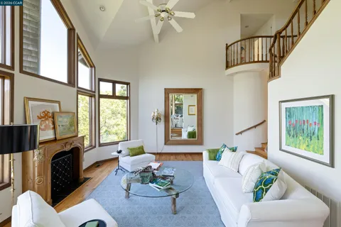 a living room with furniture fireplace and a window