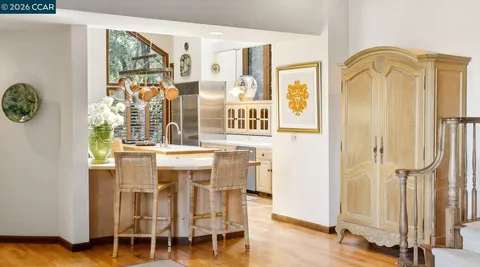 a dining room with furniture window and wooden floor