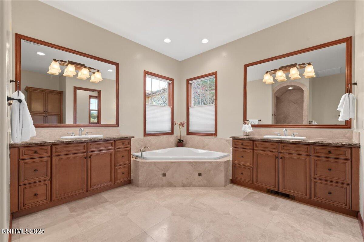 13005 Silver Wolf Road Reno, NV 89511 - Photo 34 of 40 a spacious bathroom with a granite countertop double vanity sink a mirror and a bathtub