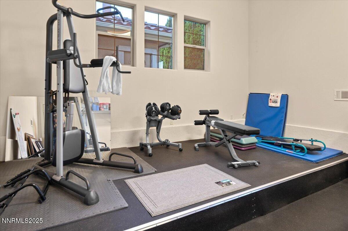 13005 Silver Wolf Road Reno, NV 89511 - Photo 38 of 40 a room with gym equipment and a view of living room