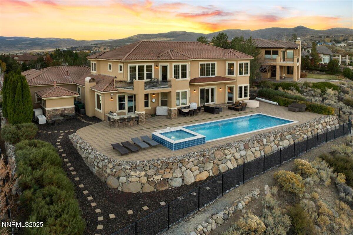 13005 Silver Wolf Road Reno, NV 89511 - Photo 4 of 40 a front view of a house with a yard fire pit and outdoor seating