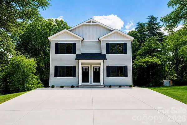 a front view of a house with a garden