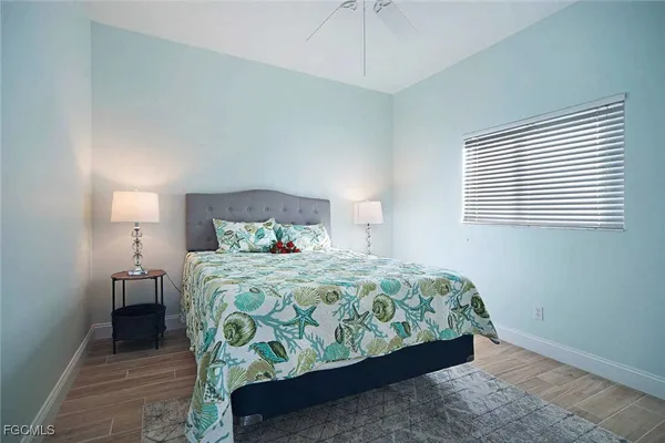 a bedroom with a bed and a lamp