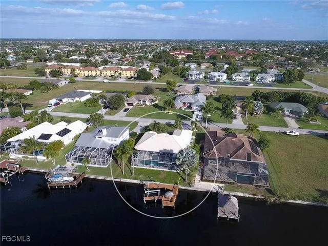 an aerial view of a house with a lake view