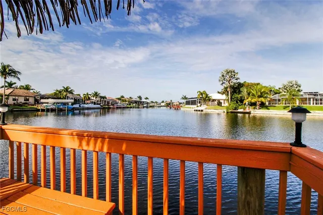 a view of swimming pool with outdoor seating and lake view