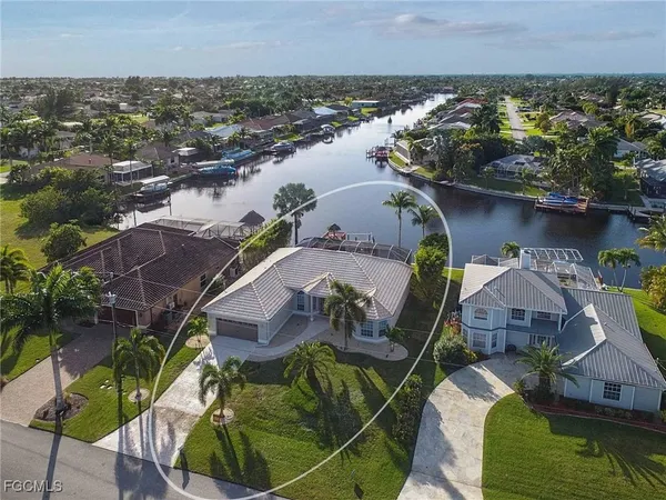 an aerial view of a house with a lake view