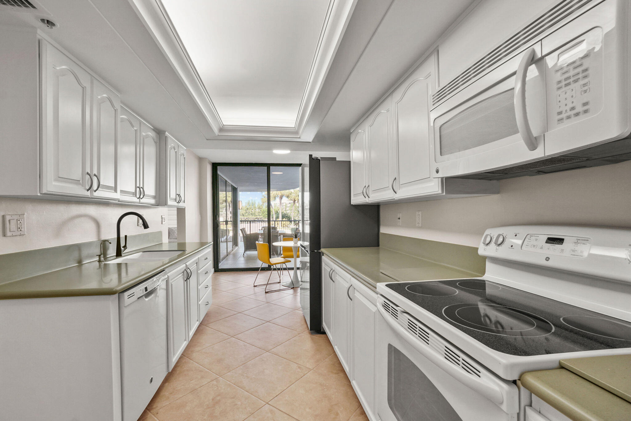 3440 South Ocean Boulevard, Unit 105S Palm Beach, FL 33480 - Photo 11 of 77 a kitchen with stainless steel appliances granite countertop a sink and cabinets