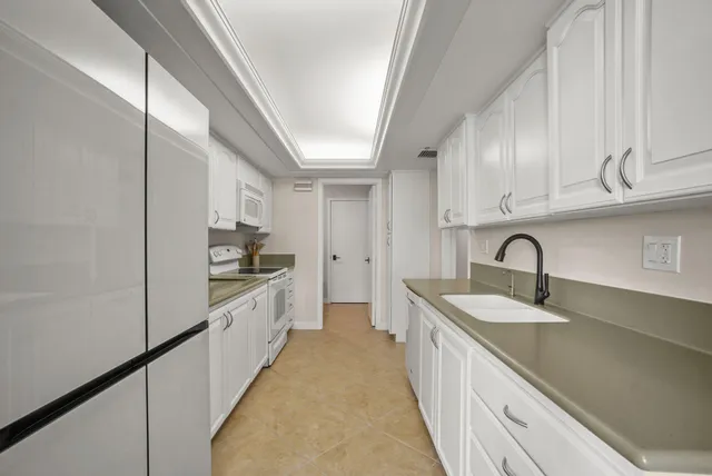 a bedroom with a bed a couch and a large window with outer view