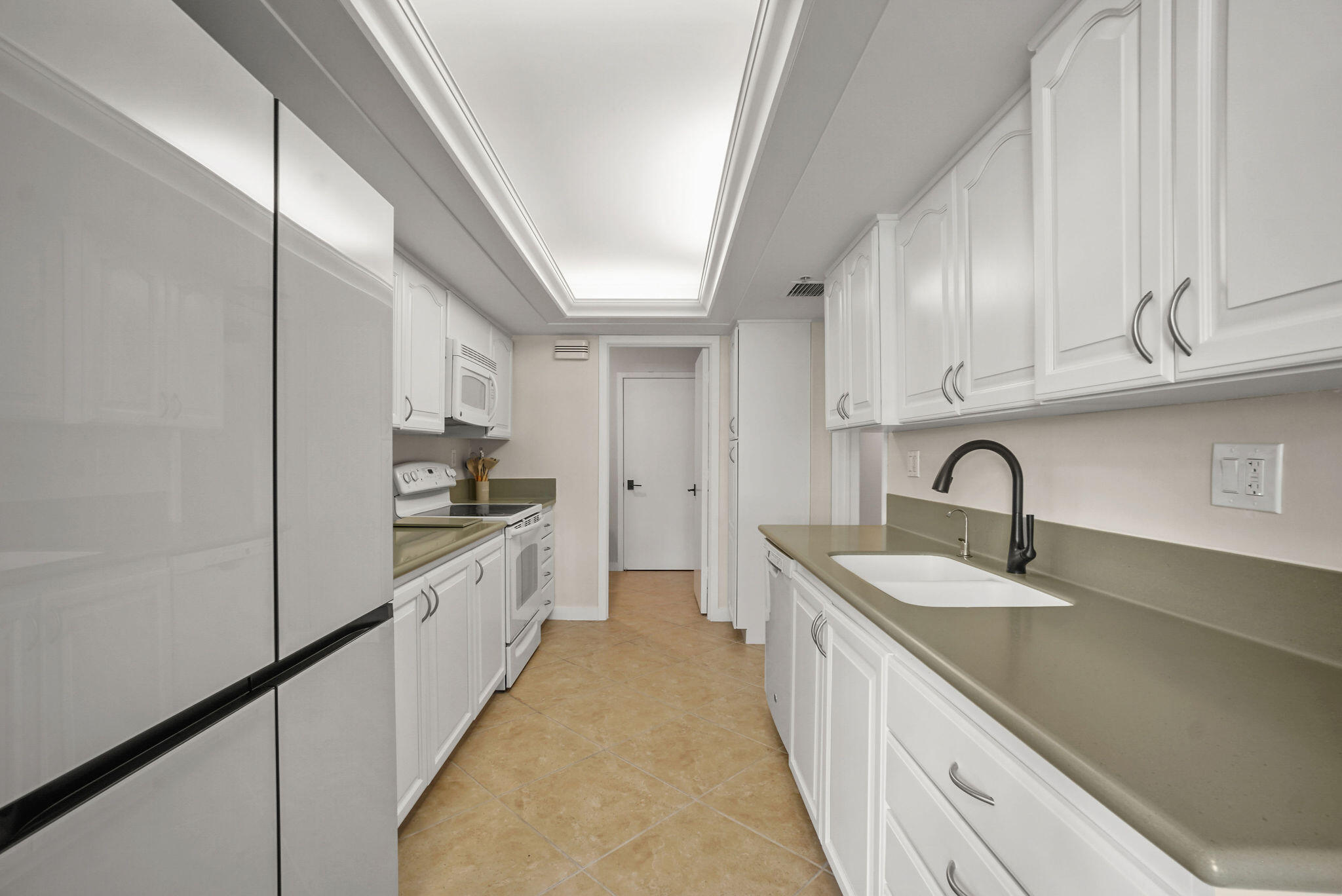 3440 South Ocean Boulevard, Unit 105S Palm Beach, FL 33480 - Photo 16 of 77 a kitchen with granite countertop a sink and cabinets