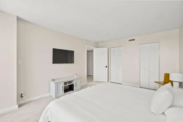 a bed room with a bed and a large window