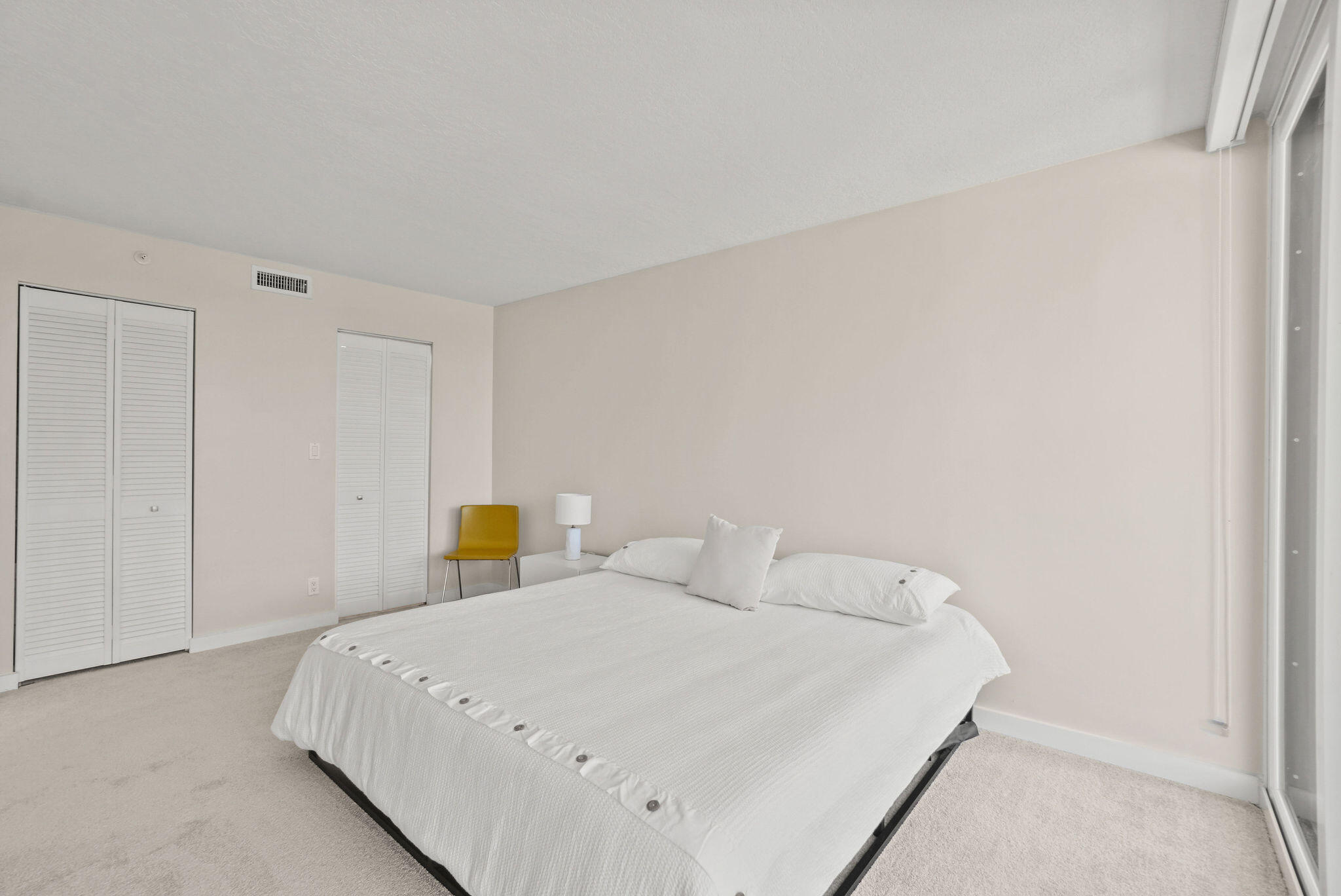 3440 South Ocean Boulevard, Unit 105S Palm Beach, FL 33480 - Photo 23 of 77 a bedroom with a bed and a window